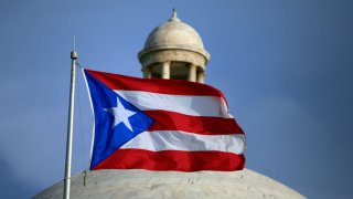 The Puerto Rican flag flies in front of Puerto Rico's Capitol as in San Juan, Puerto Rico.