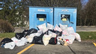 Bags of donations overflow onto the ground