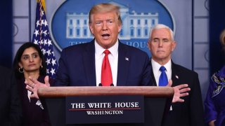 Donald Trump speaks while Vice President Mike Pence, right, and Seema Verma, administrator of the Centers for Medicare and Medicaid Services, left, listen during a Coronavirus Task Force news conference in the briefing room of the White House in Washington, D.C., U.S., on Wednesday, March 18, 2020.