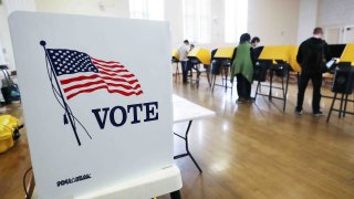 In this March 1, 2020, file photo, voters prepare their ballots in voting booths during early voting for the California presidential primary election at an LA County "vote center" in Los Angeles, California.