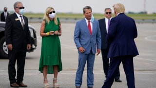 Georgia Gov. Brian Kemp, third from left, greets President Donald arrives at Hartsfield-Jackson International Airport, Wednesday, July 15, 2020, in Atlanta.