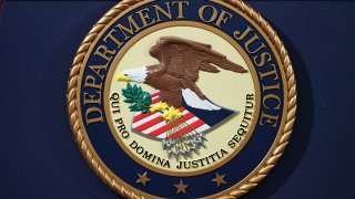 FILE - The Department of Justice seal is seen on a lectern ahead of a press conference in Washington, D.C., Nov. 28, 2018.