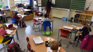 Students sit in a classroom at a primary school in Eichenau, southern Germany, on June 16, 2020 amid the novel coronavirus COVID-19 pandemic. - The pupils sit at a distance from each other and attend school in smaller classes until the summer holidays due to the pandemic.