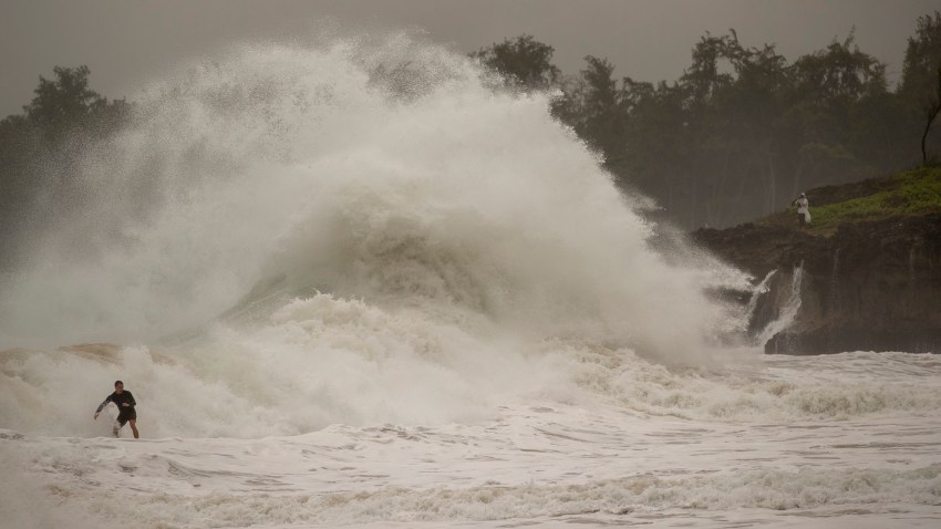 A surfer takes on a wave generated by Hurricane Douglas at Laie Beach Park, Sunday, July 26, 2020, in Laie, Hawaii.