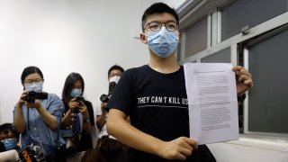 Hong Kong pro-democracy activist Joshua Wong shows his disqualification notice during a press conference in Hong Kong, Friday, July 31, 2020. On Thursday, 12 pro-democracy candidates including prominent pro-democracy activist Joshua Wong were disqualified from running in the legislative elections, as they were deemed to not comply with the Basic Law or pledge allegiance to the city and Beijing.