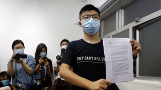 Hong Kong pro-democracy activist Joshua Wong shows his disqualification notice during a press conference in Hong Kong, Friday, July 31, 2020. On Thursday, 12 pro-democracy candidates including prominent pro-democracy activist Joshua Wong were disqualified from running in the legislative elections, as they were deemed to not comply with the Basic Law or pledge allegiance to the city and Beijing.