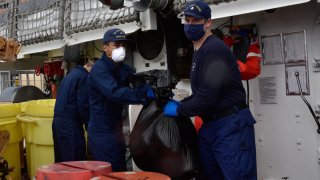 Coast Guard Cutter Legare crew members offload about 3,900 pounds of marijuana, Aug. 5, 2020, Port Everglades, Florida.