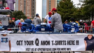 A vendor sells Qanon shirts ahead of a rally with U.S. President Donald Trump and Senator Ted Cruz, a Republican from Texas, in Houston, Texas, U.S., on Monday, Oct. 22, 2018.