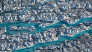 In this view from an airplane rivers of meltwater carve into the Greenland ice sheet near Sermeq Avangnardleq glacier on Aug. 4, 2019 near Ilulissat, Greenland.
