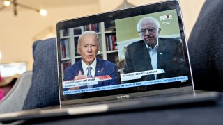 Former Vice President Joe Biden, presumptive Democratic presidential nominee, left, speaks as Senator Bernie Sanders, an Independent from Vermont, right, listens during a virtual event seen on an Apple Inc. laptop computer in Arlington, Virginia, U.S., on Monday, April 13, 2020.