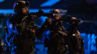 In this Aug. 16, 2020, file photo, Portland police are seen in riot gear during a standoff with protesters in Portland, Oregon.