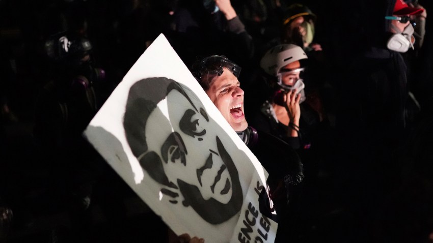 Tabitha Poppins chants in front of the Multnomah County Sheriff's Office during a protest against racial inequality and police violence on Friday, Aug. 7, 2020 in Portland, Ore.