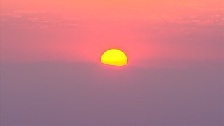 A sunrise as a wildfire burns in East County