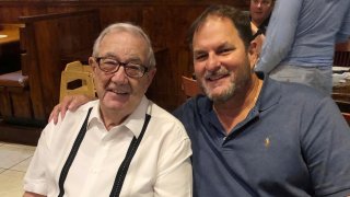Dr. Carlos Vallejo, right, celebrates Dr. Jorge Vallejo's birthday on June 12, 2020, at a Cuban restaurant in Pembroke Pines, Florida. Both have died due to COVID-19.