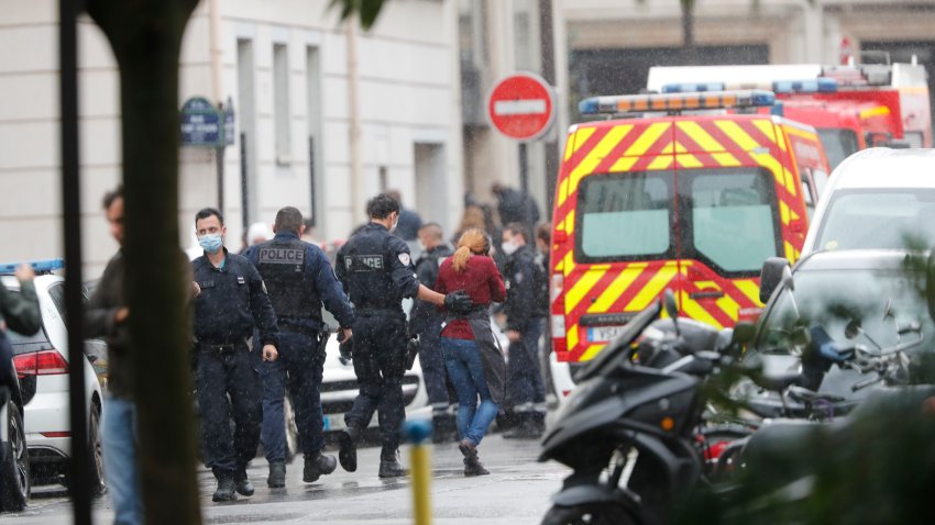 French police officers patrol the area after a knife attack near the former offices of satirical newspaper Charlie Hebdo
