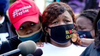 Tamika Palmer, the mother of Breonna Taylor, right, listens to a news conference