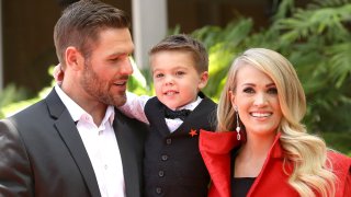 Carrie Underwood poses with her husband, Mike Fisher and their son, Isaiah Michael Fisher