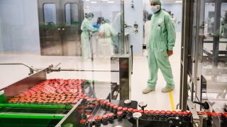 A laboratory technician supervises capped vials during filling and packaging tests for the large-scale production and supply of the University of Oxfords COVID-19 vaccine candidate, AZD1222, conducted on a high-performance aseptic vial filling line on September 11, 2020 at the Italian biologics manufacturing facility of multinational corporation Catalent in Anagni, southeast of Rome, during the COVID-19 infection, caused by the novel coronavirus.