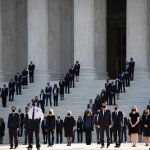 Former law clerks walk out and stand as Justice Ruth Bader Ginsburg's casket arrives at the Supreme Court in Washington, Sept. 23, 2020.