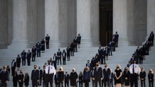 Former law clerks walk out and stand as Justice Ruth Bader Ginsburg's casket arrives at the Supreme Court in Washington, Sept. 23, 2020.