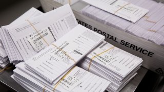 Sample voting ballots sit in a pile during a training on a new ballot sorting machine at the Board of Elections in Doylestown, Pennsylvania