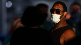 JACKSONVILLE, FLORIDA – SEPTEMBER 24: A fan wearing a mask due to Covid-19 regulations enters the stadium before the start of a game between the Jacksonville Jaguars and the Miami Dolphins at TIAA Bank Field on September 24, 2020 in Jacksonville, Florida. (Photo by James Gilbert/Getty Images)