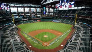 In this July 24, 2020, file photo, a general view of the inaugural game at Globe Life Field as players line the base paths for the pre-game ceremony before the game between the Colorado Rockies and the Texas Rangers at Globe Life Field in Arlington in Arlington, Texas.