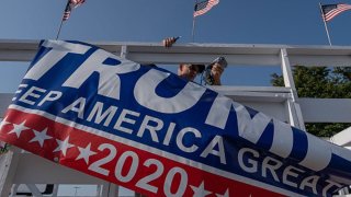 FILE PHOTO: A Trump supporter takes flags off of a wagon after celebrating his nomination and hope for his re-election in Saginaw, Michigan August 27, 2020.