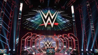WWE logos are shown on screens before a WWE news conference at T-Mobile Arena, Oct. 11, 2019, in Las Vegas, Nev.