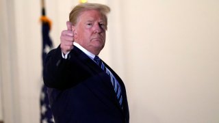 President Donald Trump gestures as he returns to the White House Monday, Oct. 5, 2020, in Washington, after leaving Walter Reed National Military Medical Center, in Bethesda, Md. Trump announced he tested positive for COVID-19 on Oct. 2.