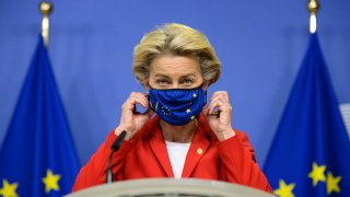 European Commission President Ursula von der Leyen, takes off her protective mask prior to making a statement regarding the Withdrawal Agreement at EU headquarters in Brussels, Thursday, Oct. 1, 2020. The European Union took legal action against Britain on Thursday over its plans to pass legislation that would breach parts of the legally binding divorce agreement the two sides reached late last year.