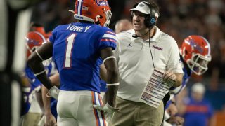 Florida head coach Dan Mullen, right, talks to Kadarius Toney during the first half as the Florida Gators play the Virginia Cavaliers during the Capital One Orange Bowl at Hard Rock Stadium Monday, Dec. 30, 2019 in Miami Gardens, Fla. (Al Diaz/Miami Herald/TNS)