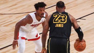 Jimmy Butler #22 of the Miami Heat defends LeBron James #23 of the Los Angeles Lakers