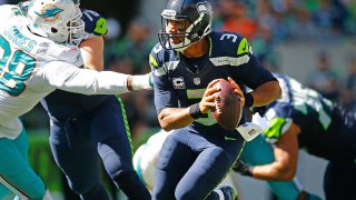 SEATTLE, WA – SEPTEMBER 11: Quarterback Russell Wilson #3 of the Seattle Seahawks tries to evade the Miami Dolphins defense in the first half at CenturyLink Field on September 11, 2016 in Seattle, Washington. (Photo by Jonathan Ferrey/Getty Images) *** Local Caption *** Russell Wilson