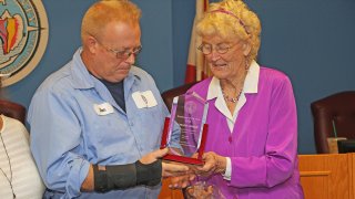 Donald Lowrie, left, is seen with Commissioner Sylvia Murphy receiving the 2018 Employee of the Year award.