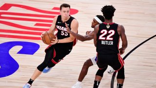 Duncan Robinson #55 of the Miami Heat drives the ball as Jimmy Butler #22 of the Miami Heat blocks during the fourth quarter in Game Six of the 2020 NBA Finals at AdventHealth Arena at the ESPN Wide World Of Sports Complex on October 11, 2020 in Lake Buena Vista, Florida.