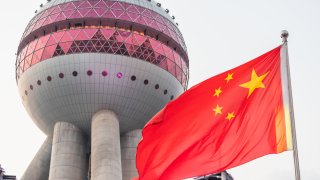 A Chinese national flag seen in front of Oriental Pearl Tower in Shanghai on September 8, 2019.