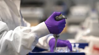 Scientist Xinhua Yan works in the lab at Moderna in Cambridge, MA on Feb. 28, 2020. Moderna has developed the first experimental coronavirus medicine, but an approved treatment is more than a year away.