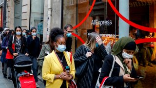 People wait in line in front of the AliExpress pop-up store in Paris on September 24, 2020.