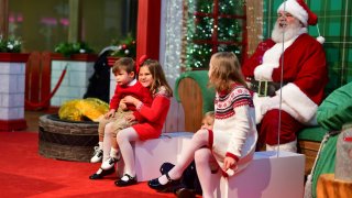 Siblings Jack, Catherine, Sam and Molly Matt pay a socially distant visit to Santa Claus at the Willow Grove Park Mall in Willow Grove, Pennsylvania, on Nov. 14, 2020.