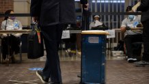 An election worker waits to secure ballots at Ford Field on November 3, 2020 in Detroit, Michigan.