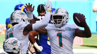 MIAMI GARDENS, FLORIDA – NOVEMBER 01: Tua Tagovailoa #1 of the Miami Dolphins celebrates his first NFL touchdown on a three-yard pass to DeVante Parker #11 against the Los Angeles Rams during their game at Hard Rock Stadium on November 01, 2020 in Miami Gardens, Florida. (Photo by Mark Brown/Getty Images)