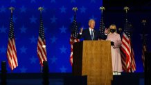 Democratic presidential nominee Joe Biden speaks at a drive-in election night event as Dr. Jill Biden looks on at the Chase Center in the early morning hours of November 04, 2020 in Wilmington, Delaware.