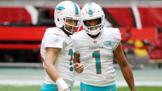 GLENDALE, ARIZONA – NOVEMBER 08: Ryan Fitzpatrick #14 of the Miami Dolphins and Tua Tagovailoa #1 talk during warmups before the game against the Arizona Cardinals at State Farm Stadium on November 08, 2020 in Glendale, Arizona. (Photo by Chris Coduto/Getty Images)