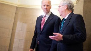 Vice President Joe Biden, left, and Senate Majority Leader Mitch McConnell, R-Ky., make their way to the House floor for President Obama's State of the Union address, January 12, 2016.