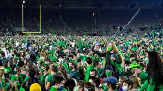 Fans storm the field after Notre Dame defeated the Clemson 47-40 in two overtimes in an NCAA college football game Saturday, Nov. 7, 2020, in South Bend, Indiana.