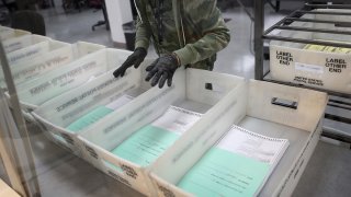 A worker at the Miami-Dade County Elections Department works on tabulating the Vote by Mail ballots that have been returned for the general election on October 30, 2020 in Doral, Florida. Historic numbers of vote-by-mail ballots have been returned ahead of the Nov. 3rd election day as people have concerns about the coronavirus and election security in general.