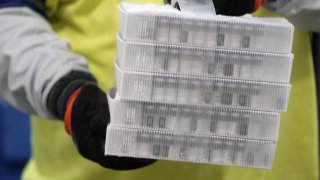 Vials in boxes containing the Pfizer-BioNTech Covid-19 vaccine are prepared to be shipped at the Pfizer Global Supply Kalamazoo manufacturing plant in Kalamazoo, Michigan on December 13, 2020.