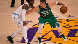 Wesley Matthews #9 of the Los Angeles Lakers guards Luka Doncic #77 of the Dallas Mavericks at Staples Center on December 25, 2020 in Los Angeles, California.