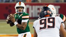 Miami quarterback D'Eriq King looks for a receiver as Oklahoma State defensive tackle Sione Asi rushes during the first half of the Cheez-it Bowl